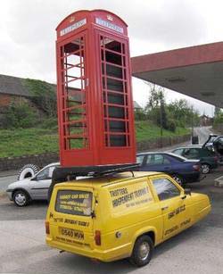 Picture of a Phoney Box being carried vertically on the Trotter's yellow Reliant van